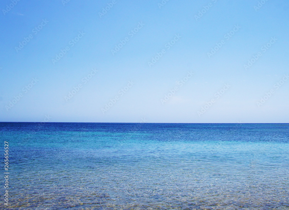 Blue sea landscape with sky on the horizon. Calm ocean waves summer tropics lagoon.