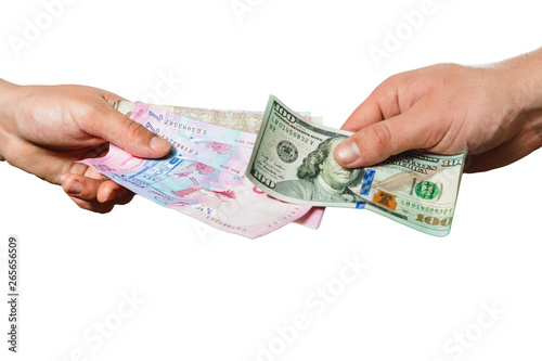 People exchange hryvnia for dollars, only hands can be seen on a black background.