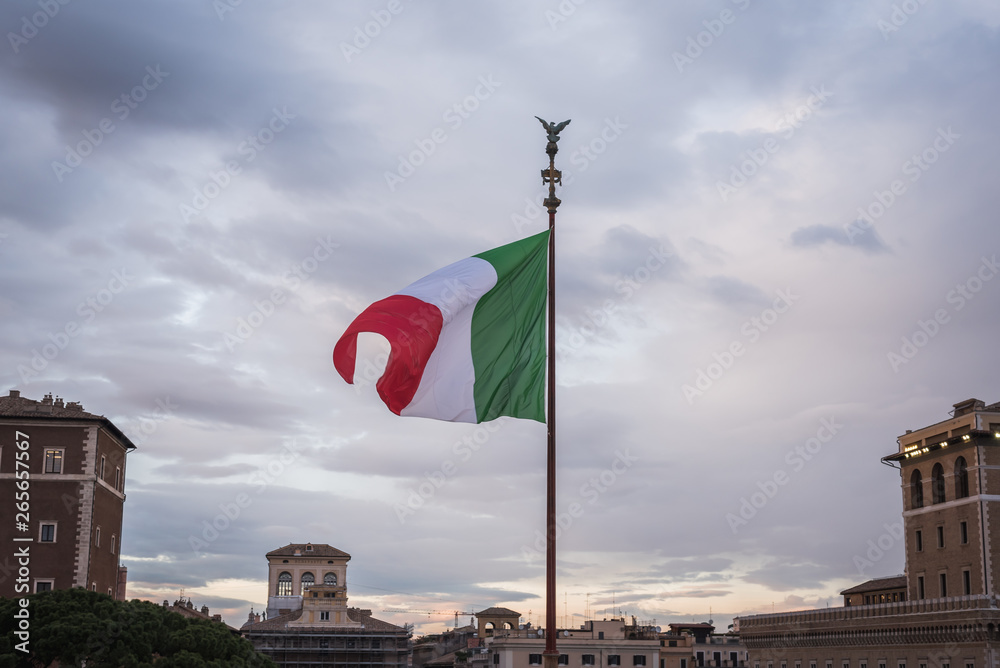 Italian flag floating on the monument Vittorio Emanuele II in Rome