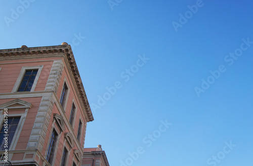 Old house building against the blue sky. Architecture of an old medieval european italian city.