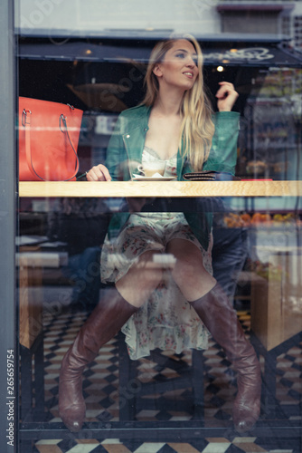 Young Fashion Girl In Caffe Store Window