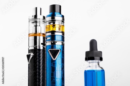 Electronic cigarettes and bottle with vape liquid on white background