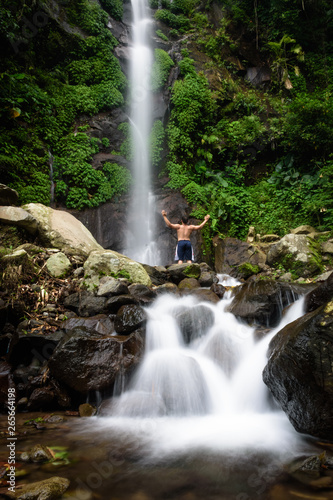 Beautiful scene of Semirang Waterfall with lovely smooth water. A man standing and enjoying a gorgeous waterfall. A Waterfall which is a tourist destination in the city of Ungaran