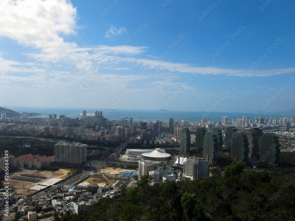 China, Hainan Province, view of the city of Sanya, in the foreground of the house, apple trees. Horizontal photo