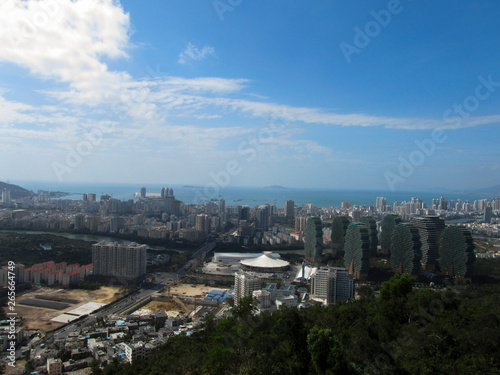 China, Hainan Province, view of the city of Sanya, in the foreground of the house, apple trees. Horizontal photo