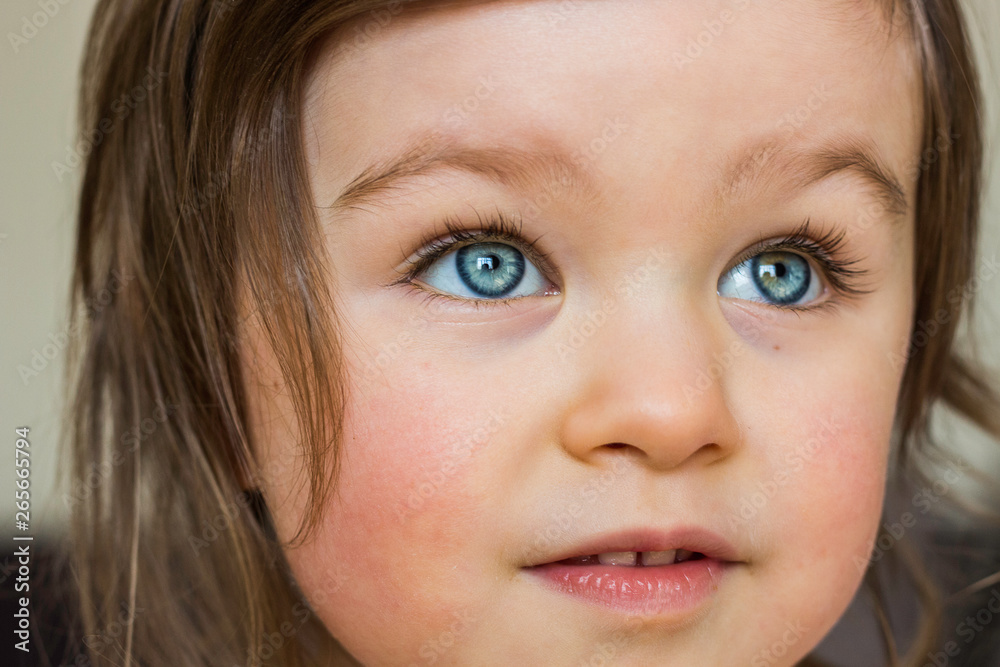 Beautiful Baby Toddler Looks Attentively. Closeup Portrait of Child with Blue Eyes Beautiful Baby Toddler Looks Attentively. Closeup Portrait of Child with Blue Eyes