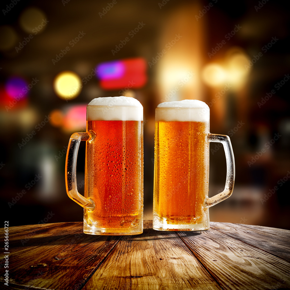 Fresh cold beer in glass and free space for your bottle. Bar interior background Fresh cold beer in glass and free space for your bottle. Bar interior background