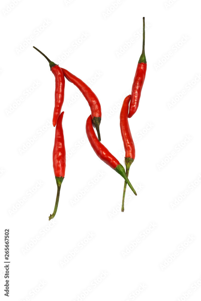 Alphabet of hot spice cayenne chili peppers isolated on white. Vegetable chili peppers in shape of letter N, for making words and logo Alphabet of hot spice cayenne chili peppers isolated on white. Vegetable chili peppers in shape of letter N, for making words and logo