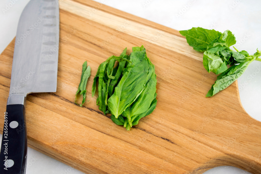 Julienned Basil Leaves on a Cutting Board Julienned Basil Leaves on a Cutting Board