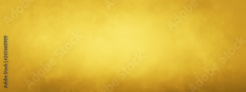 Gold background texture. Soft yellow and brown old vintage paper background design in elegant textured luxury design.