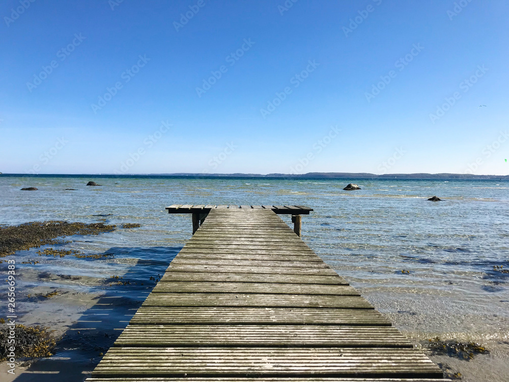 Wooden pier on Baltic sea during low water