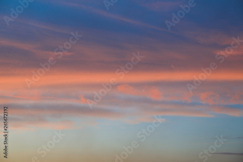 Dramatic sunset sky background with fiery clouds, yellow, orange and pink colour, nature background. Beautiful skies © Atlas