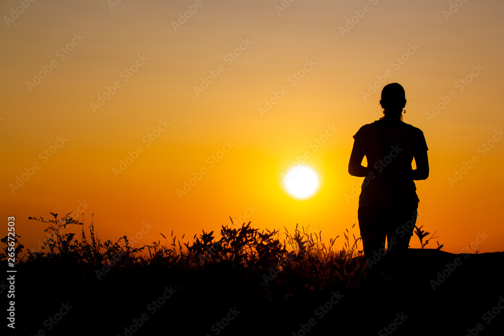 Orange and Yellow Sunset Silhouette of a woman