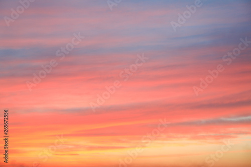 Fototapeta Naklejka Na Ścianę i Meble -  Dramatic sunset sky background with fiery clouds, yellow, orange and pink colour, nature background. Beautiful skies