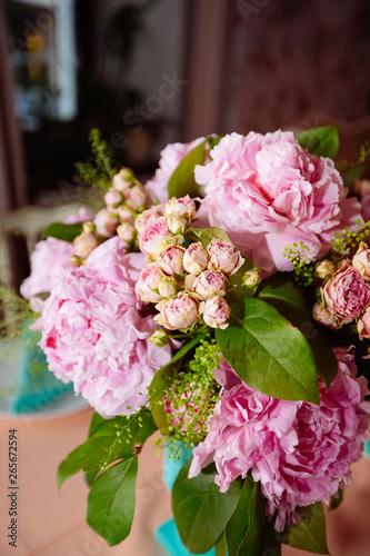 Beautiful bright bouquet of peony on the wedding table in vase