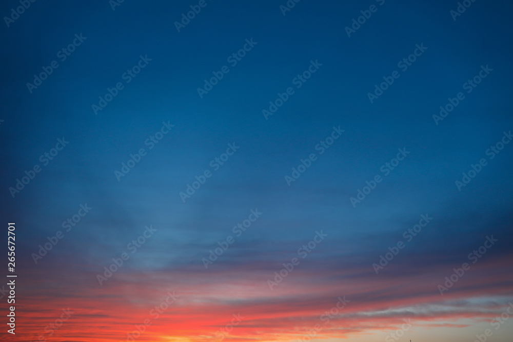 Dramatic sunset sky background with fiery clouds, yellow, orange and pink colour, nature background. Beautiful skies