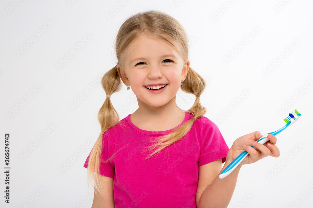 Happy little girl standing with toothbrush isolated on white.little child brush his teeth.Cute little girl is brushing teeth with a smile.dental hygiene. happy little girl brushing her tooth Happy little girl standing with toothbrush isolated on white.little child brush his teeth.Cute little girl is brushing teeth with a smile.dental hygiene. happy little girl brushing her tooth
