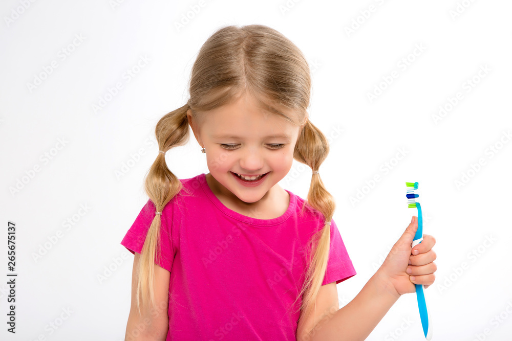 Happy little girl standing with toothbrush isolated on white.little child brush his teeth.Cute little girl is brushing teeth with a smile.dental hygiene. happy little girl brushing her tooth Happy little girl standing with toothbrush isolated on white.little child brush his teeth.Cute little girl is brushing teeth with a smile.dental hygiene. happy little girl brushing her tooth