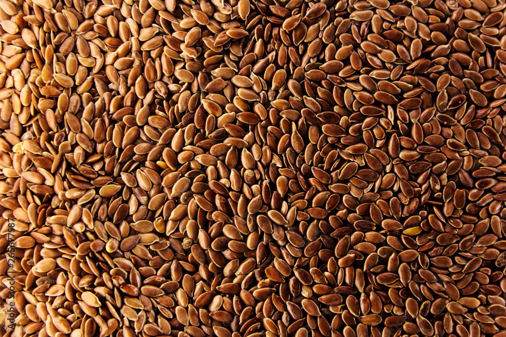 Brown flax seeds give flaxseed oil background Brown flax seeds give flaxseed oil background