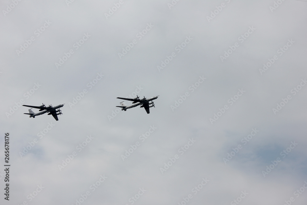 Two aircrafts of russian armed forces flying on cloudy sky background in St. Petersburg, Russia Two aircrafts of russian armed forces flying on cloudy sky background in St. Petersburg, Russia