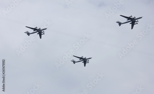 Fototapeta Naklejka Na Ścianę i Meble -  Armed fighter jet planes of Russian military aviation flying on empty sky background in St. Petersburg, Russia