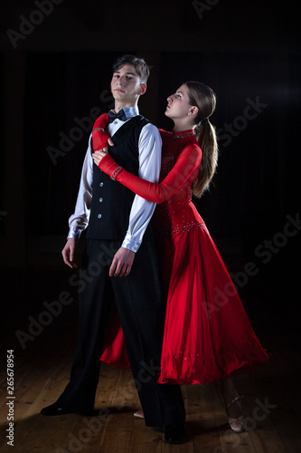Beautiful young dancers in ballroom isolated on black background