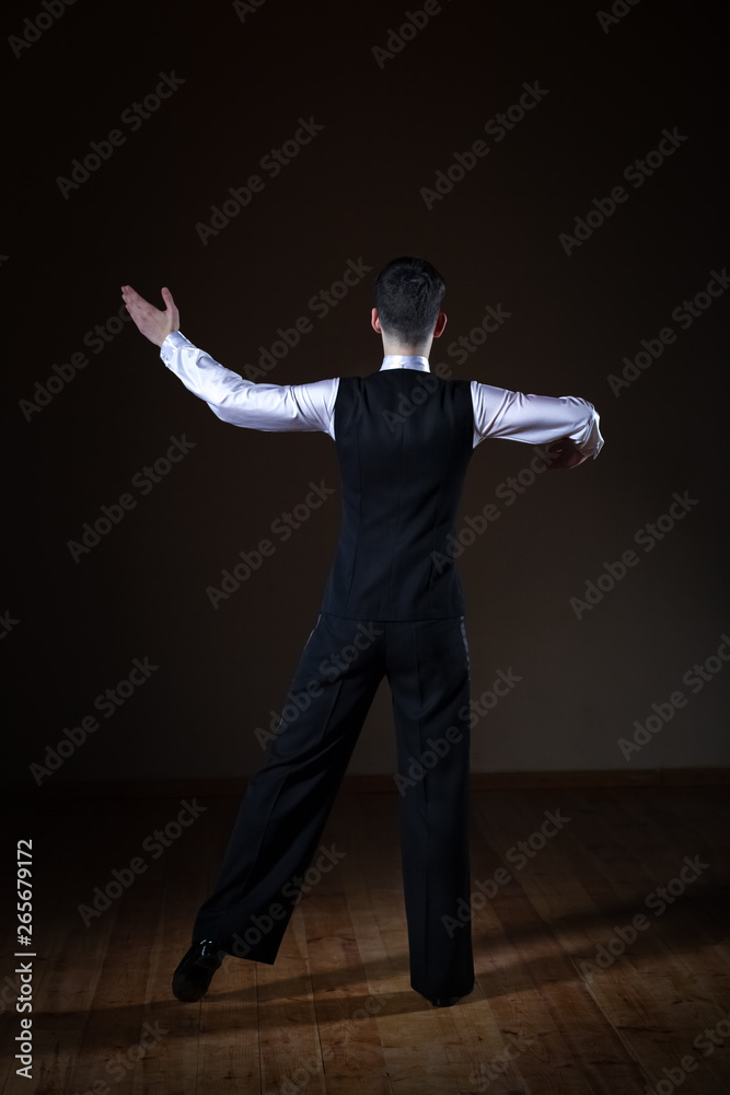 young dancer in the ballroom on a black background young dancer in the ballroom on a black background