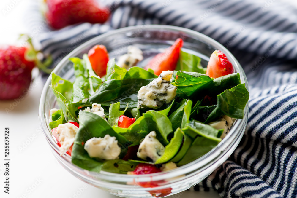 bowl of vegan  salad with strawberries and blue cheese