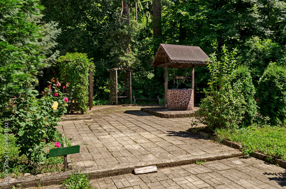 Well with concrete base and wooden construction in the monastery place for relax, mountain Balkan, near Varshets town, Bulgaria, Europe Well with concrete base and wooden construction in the monastery place for relax, mountain Balkan, near Varshets town, Bulgaria, Europe