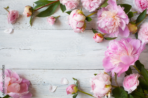 Fototapeta Naklejka Na Ścianę i Meble -  Pink peonies and roses on a wooden background
