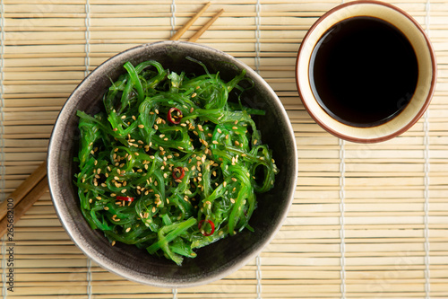 Wakame seaweed salad with sesame and chili pepper photo