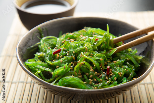 Wakame seaweed salad with sesame and chili pepper photo