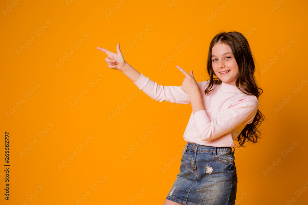baby girl smiling showing like on yellow background, space for text baby girl smiling showing like on yellow background, space for text
