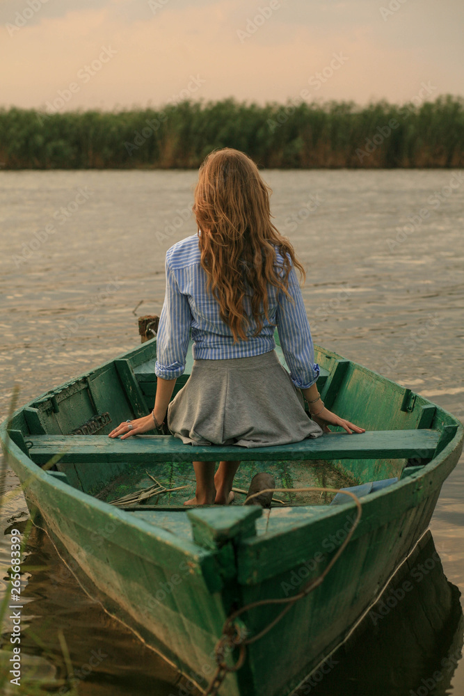 Girl floating on a boat on the river