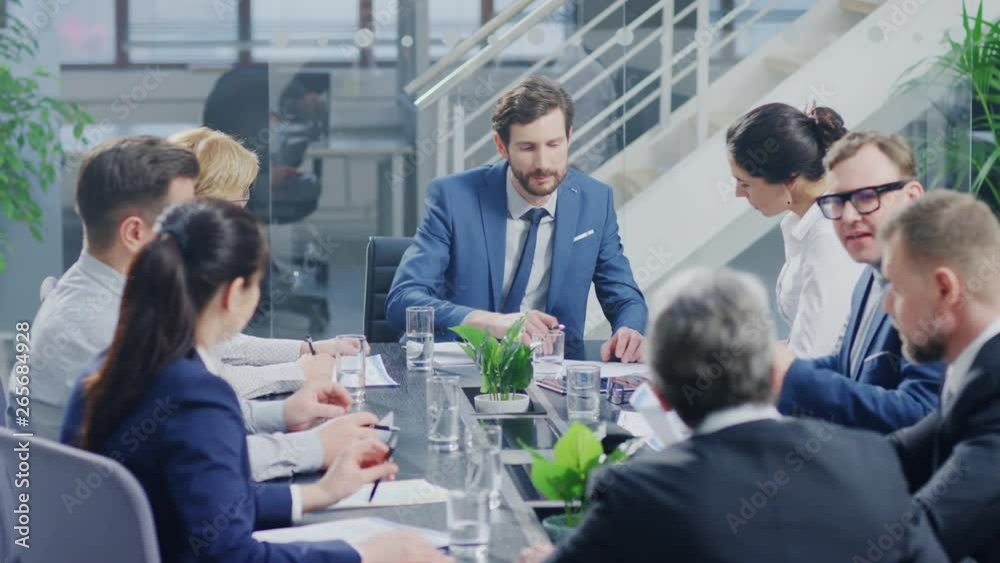 In the Modern Corporate Office Meeting Room: Diverse Group of Businesspeople, Lawyers, Executives and Members of the Board of Directors Talking, Negotiating, Use Documents and Consult Statistic Graphs In the Modern Corporate Office Meeting Room: Diverse Group of Businesspeople, Lawyers, Executives and Members of the Board of Directors Talking, Negotiating, Use Documents and Consult Statistic Graphs