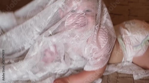 Household scene with a child in the house  Little boy emotional and happy is played by wrapping himself in cloth 