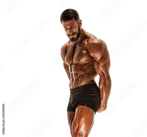 Handsome Competitive Bodybuilder Flexing Muscles. He is showing Side Triceps Pose