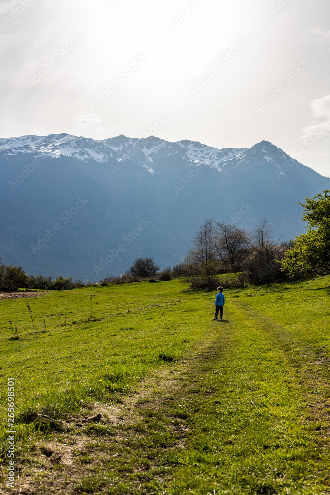 Little boy looking the snowy Pyrinees  mountains