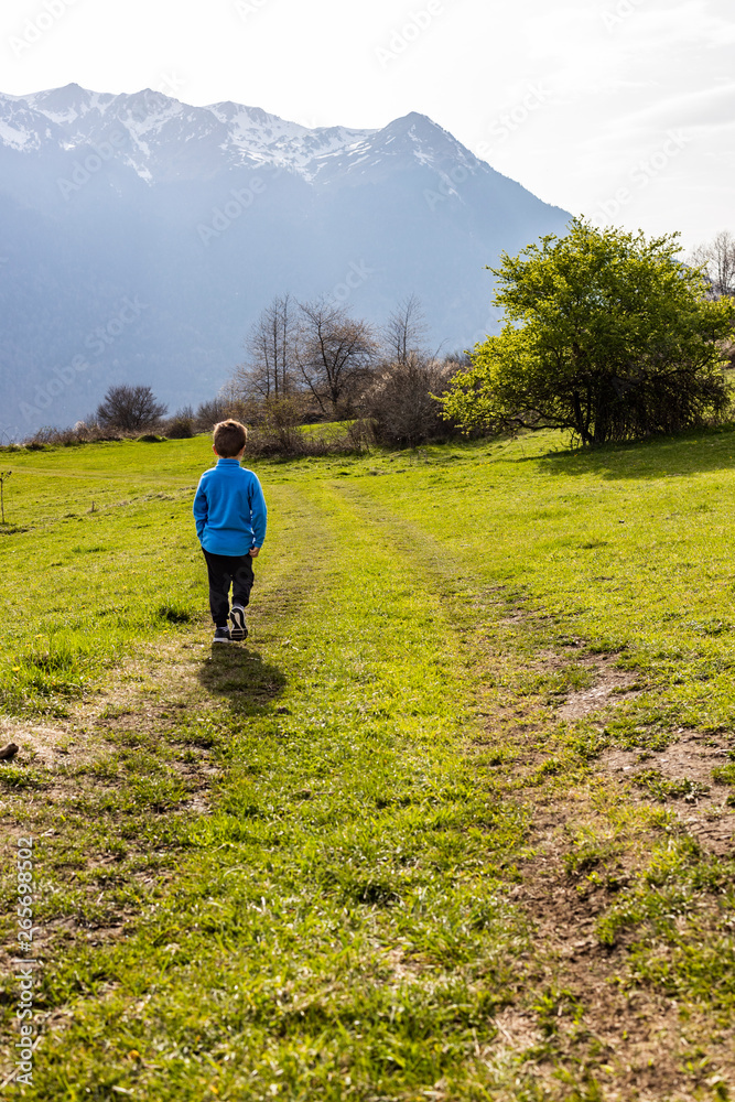 Little boy looking the snowy Pyrinees  mountains