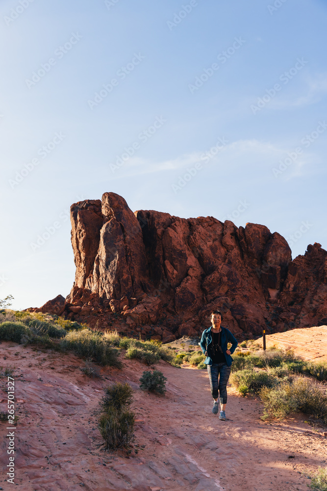 Senior Asian Woman Hiking in Valley of Fire State Park, Nevada, North America Senior Asian Woman Hiking in Valley of Fire State Park, Nevada, North America