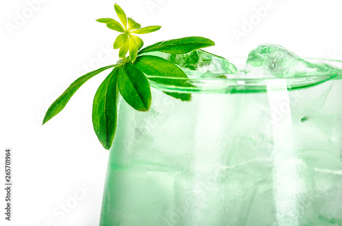 green woodruff drink with ice cubes on white background, isolated photo