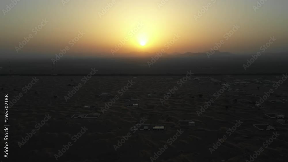 Aerial view of an empty abandoned village and homes covered in desert sand near Dubai. Aerial view of an empty abandoned village and homes covered in desert sand near Dubai.