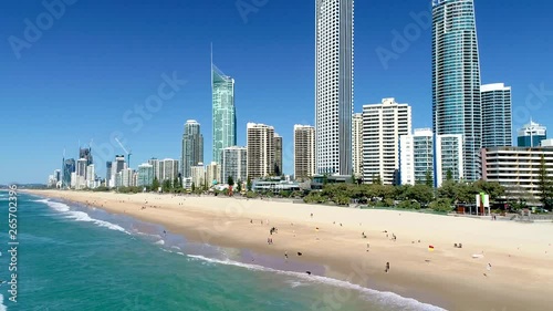 Pull-out reveal aerial shot of the skyscrapers and beaches of Surfers Paradise Gold Coast Queensland Australia on a perfect blue sky day. photo