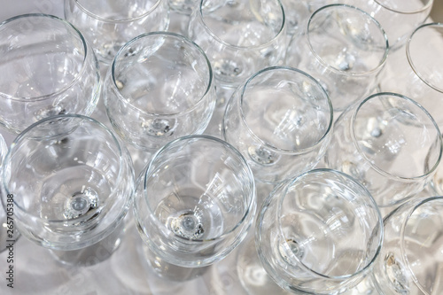 lot of blurred empty glasses on reception party table