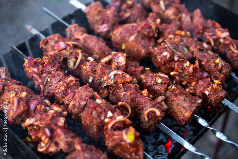 roasted meat, skewers with onions on skewers on the grill