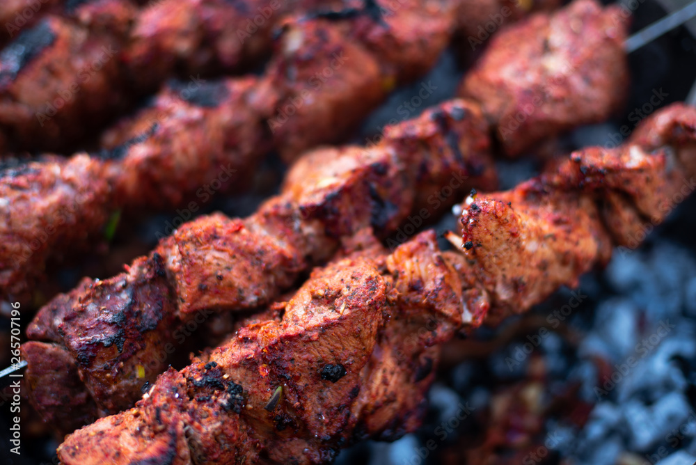 roasted meat, skewers with onions on skewers on the grill
