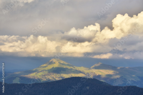 Mountain peaks with clouds approaching them