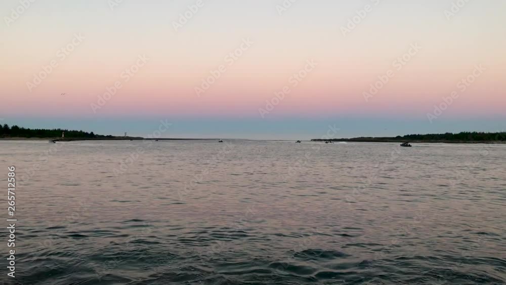 Fishing boats going out in the bay at sunrise. Fishing boats going out in the bay at sunrise.
