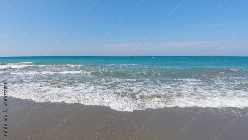 Watching the waves of the Mediterranean Sea at the beach at the beautiful island of Rhodes Greece Watching the waves of the Mediterranean Sea at the beach at the beautiful island of Rhodes Greece