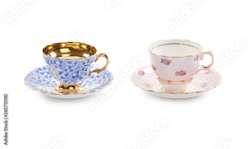 High resolution close-up of two beautiful antique tea cups with saucers isolated on a white background.